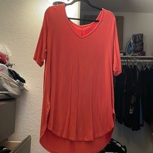 It's a salmon color knit blouse